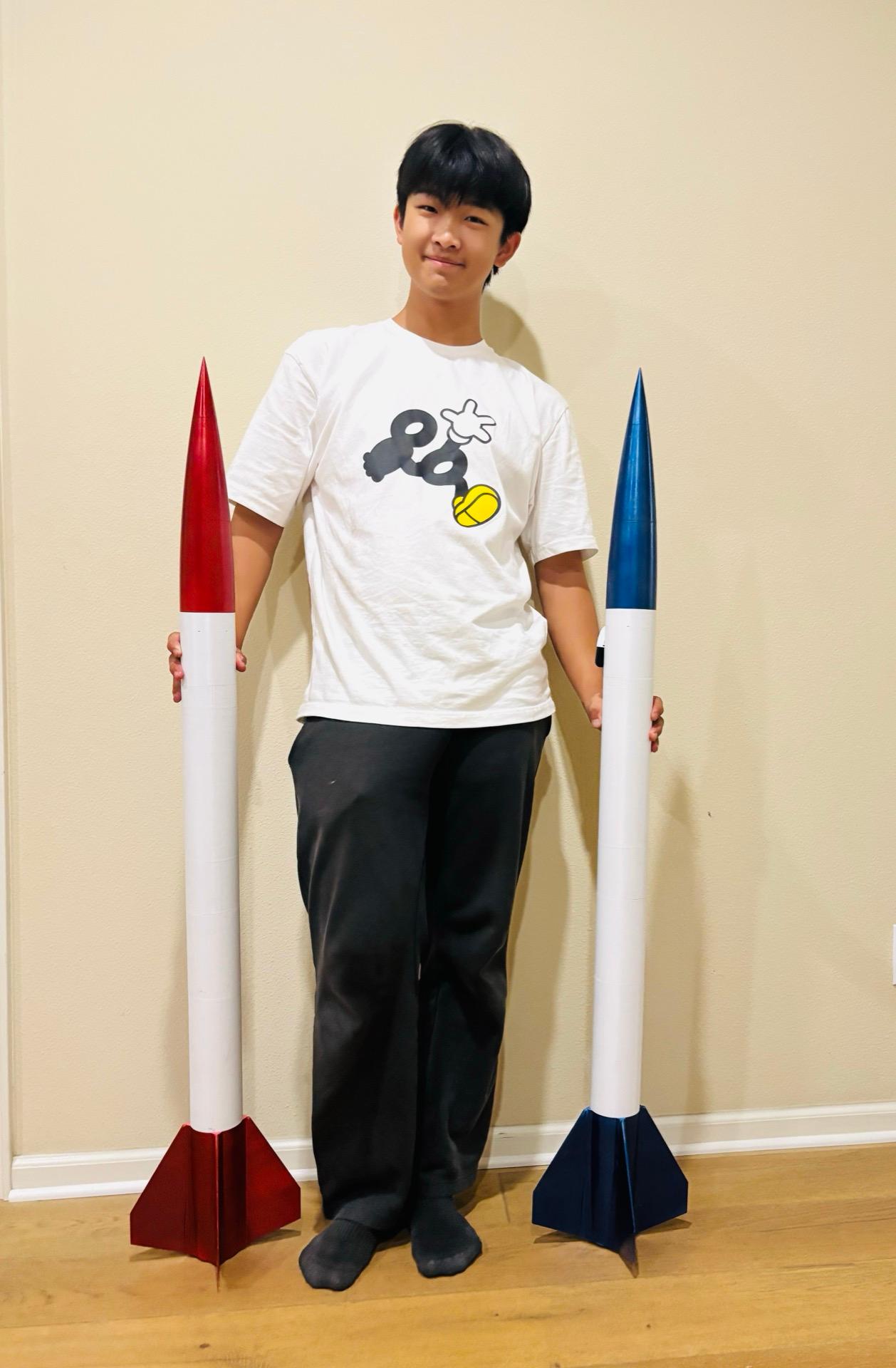 Eric Song holding model rockets