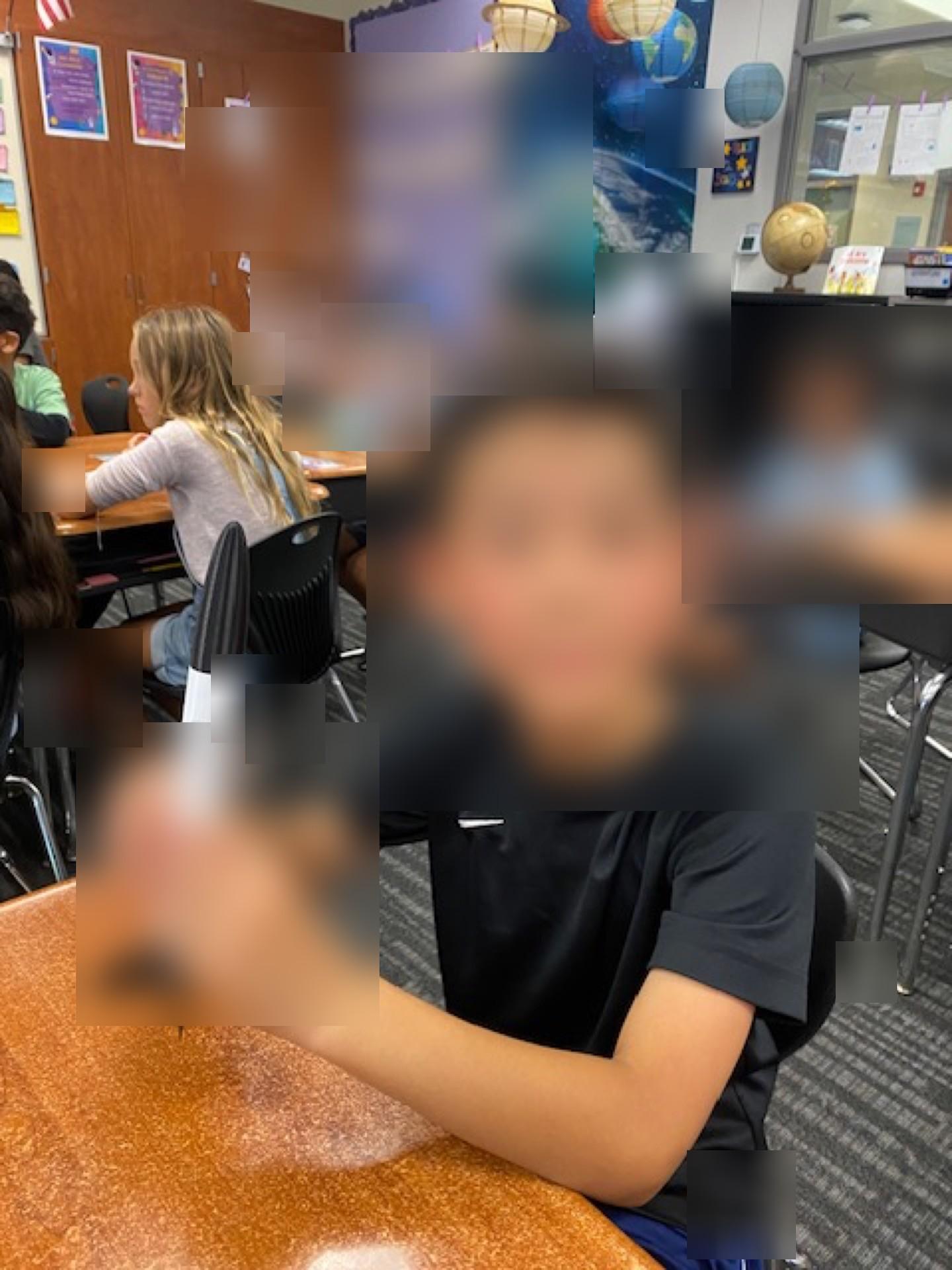 Student holding a mini rocket in classroom